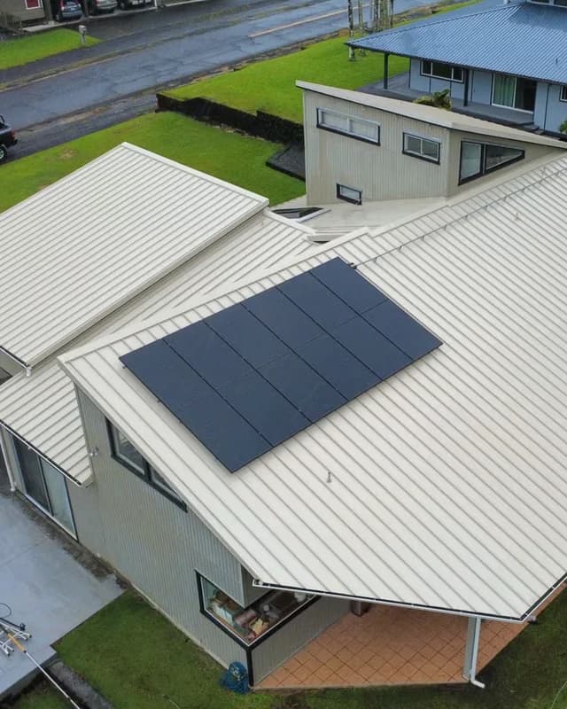 Raw jobsite photo of a metal roof solar install